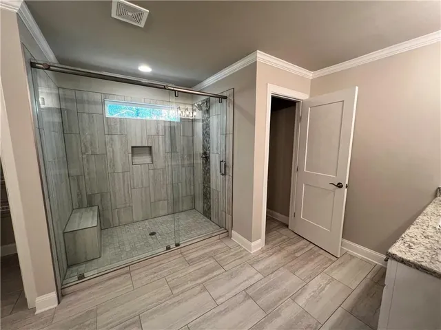 a bathroom with a shower and a tub