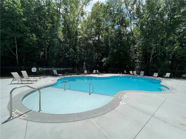 a view of a swimming pool with a yard