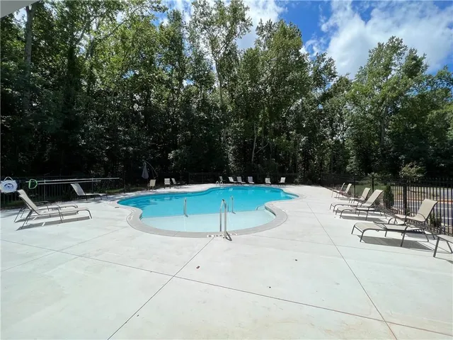 a view of a swimming pool with a yard