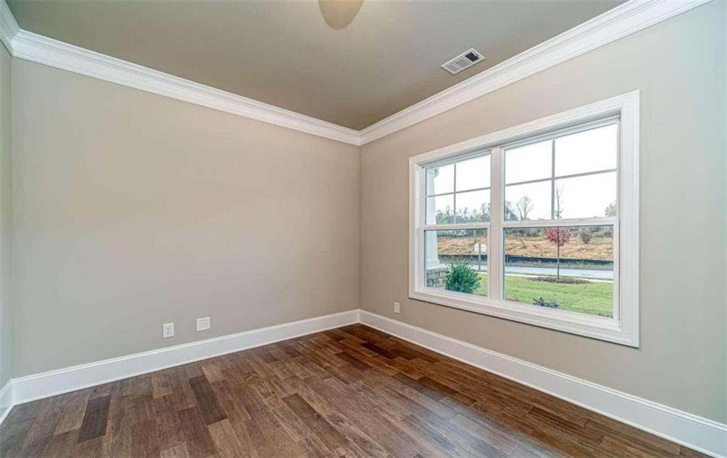 514 Adventure Trail Jefferson, GA 30549 - Photo 10 of 49 an empty room with wooden floor and windows