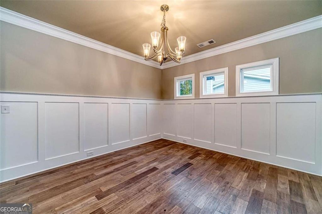 514 Adventure Trail Jefferson, GA 30549 - Photo 10 of 48 a view of an empty room with window and wooden floor