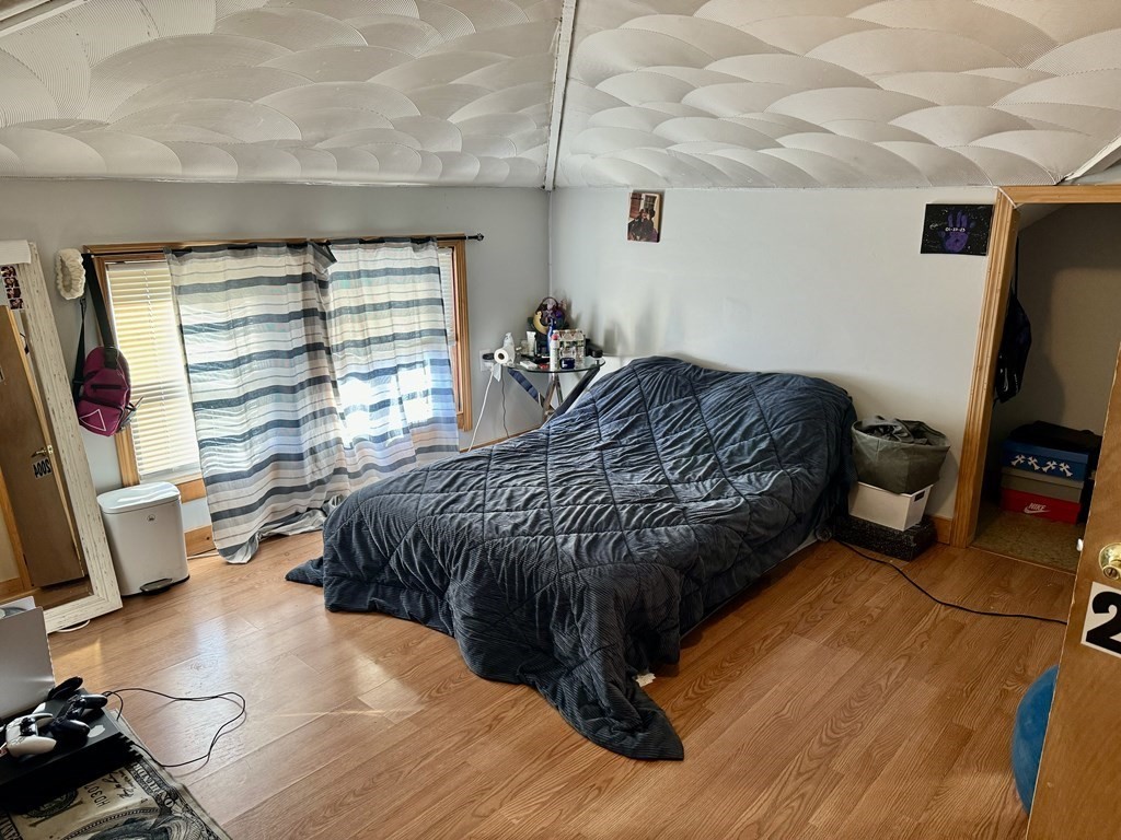 98 Shute Street Everett, MA 02149 - Photo 15 of 37 a bedroom with a bed and a flat screen tv