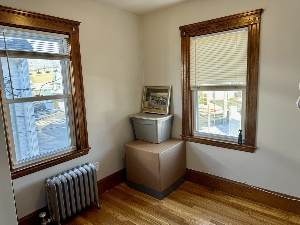 98 Shute Street Everett, MA 02149 - Photo 18 of 37 a view of an empty room with a window and wooden floor
