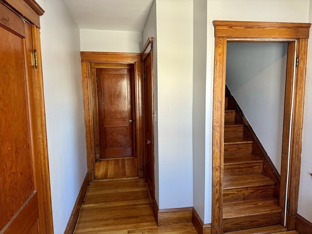 98 Shute Street Everett, MA 02149 - Photo 19 of 37 a view of a hallway with wooden floor and entryway