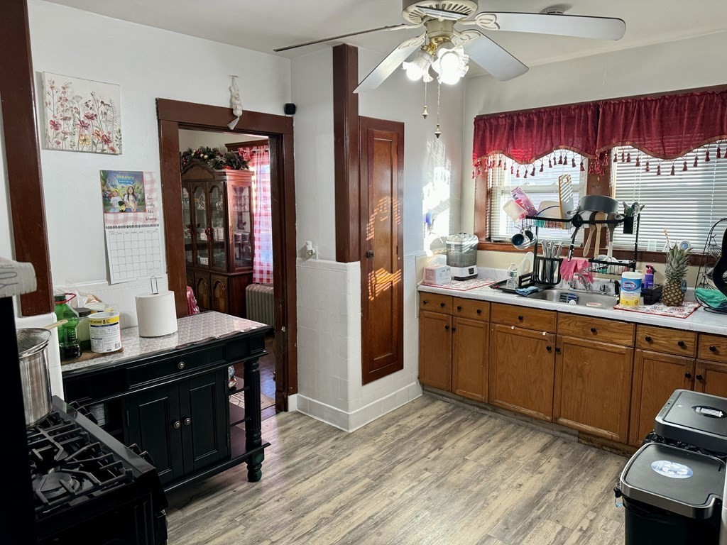 98 Shute Street Everett, MA 02149 - Photo 21 of 37 a kitchen with stainless steel appliances granite countertop a stove cabinets and wooden floor