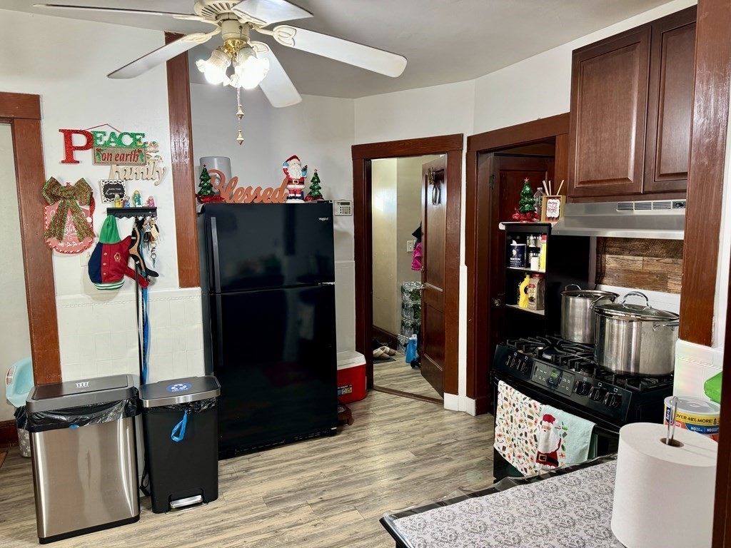 98 Shute Street Everett, MA 02149 - Photo 22 of 37 a living room with furniture a flat screen tv and a refrigerator