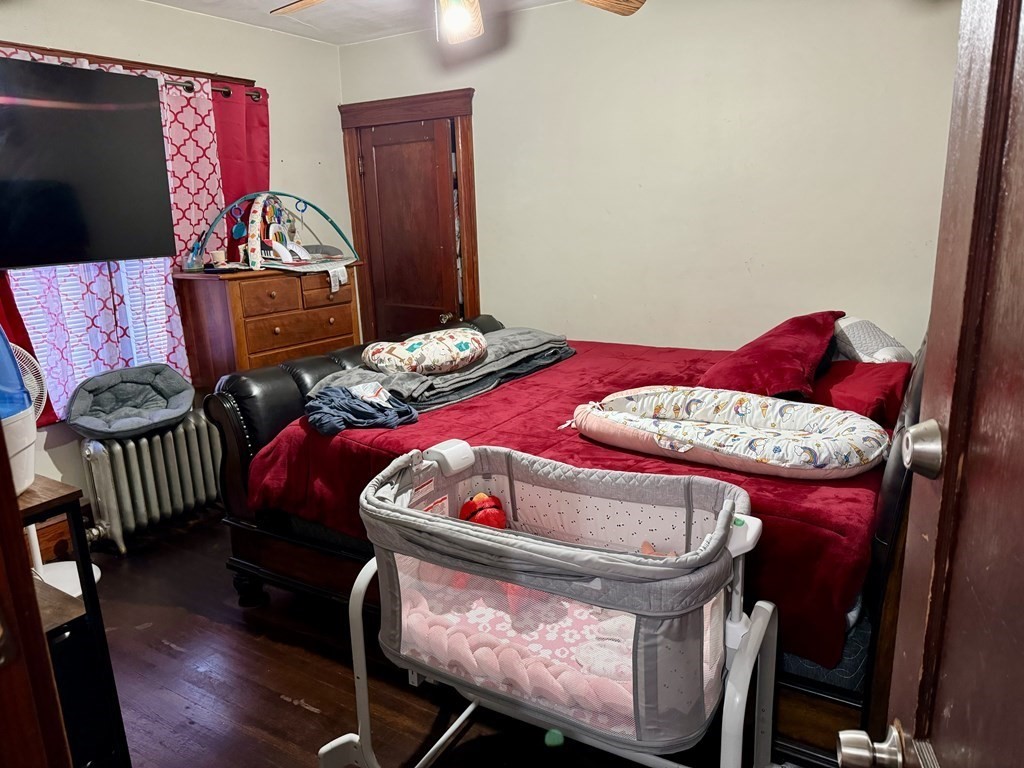 98 Shute Street Everett, MA 02149 - Photo 27 of 37 a bedroom with a bed and a dresser