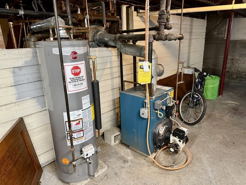 98 Shute Street Everett, MA 02149 - Photo 34 of 37 a utility room with dryer and bicycles