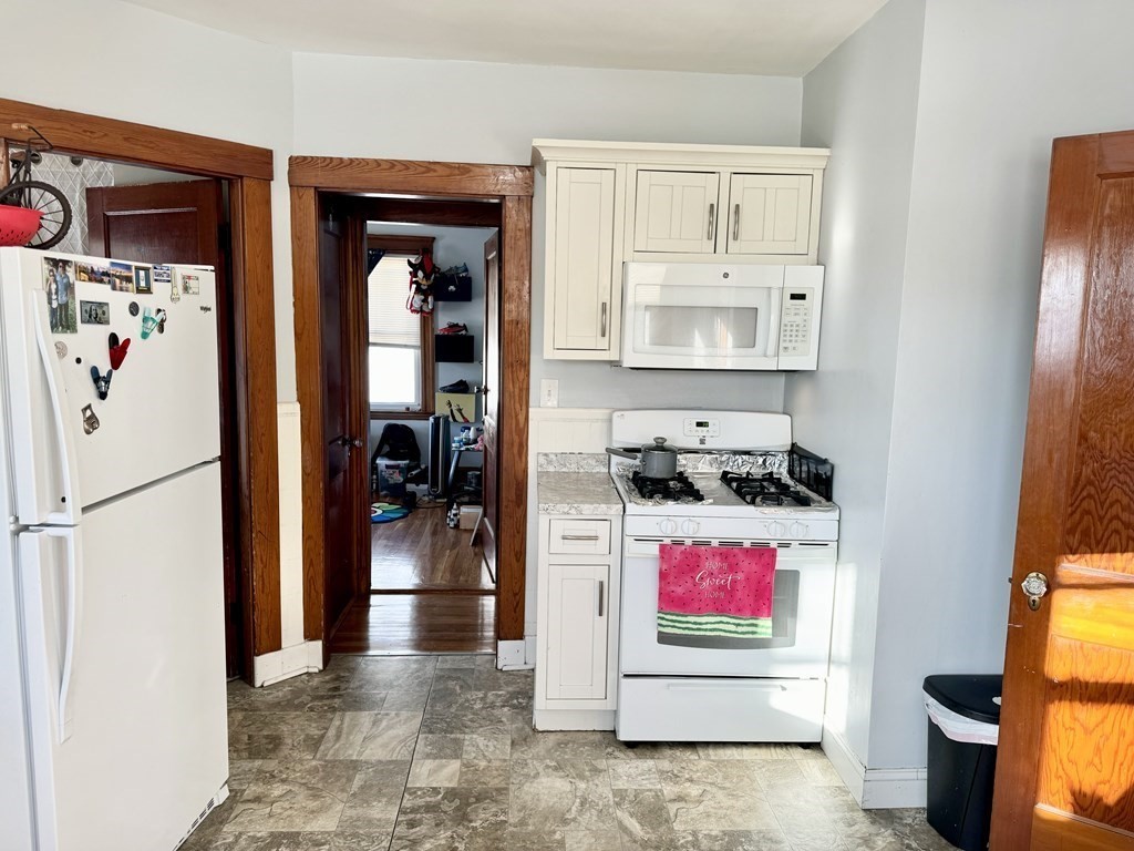 98 Shute Street Everett, MA 02149 - Photo 5 of 37 a kitchen with stainless steel appliances granite countertop a refrigerator and a stove