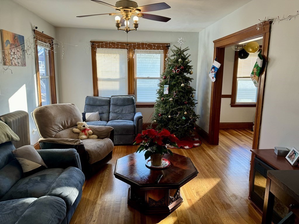 98 Shute Street Everett, MA 02149 - Photo 8 of 37 a living room with furniture and a chandelier