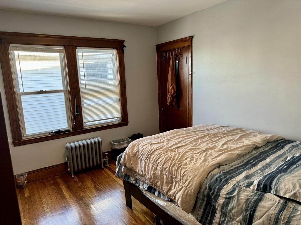 98 Shute Street Everett, MA 02149 - Photo 10 of 37 a bed sitting in a bedroom next to a window