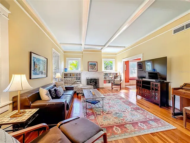 a living room with stainless steel appliances furniture stove and a kitchen view