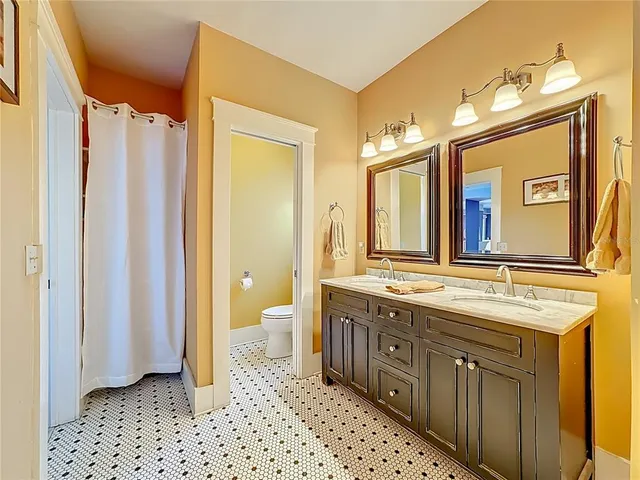 a view of a house with wooden floor next to a yard