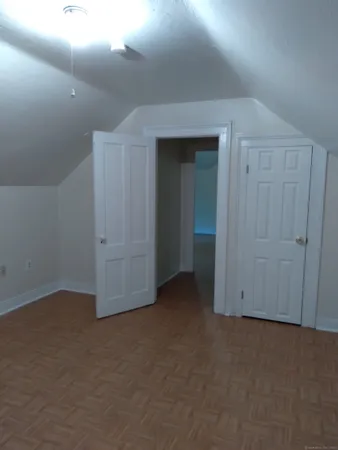 a view of an empty room and closet area