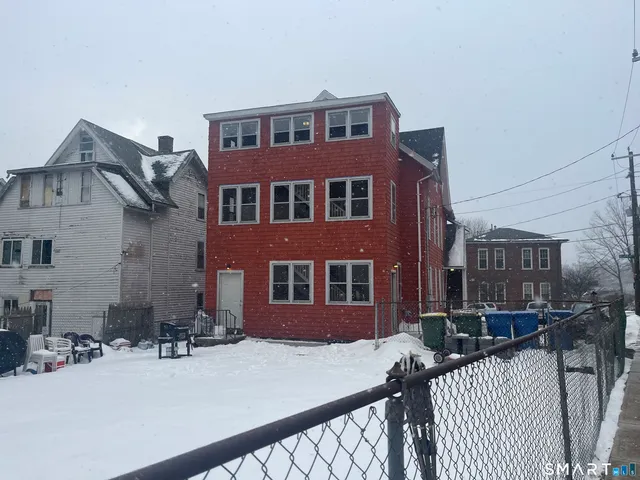 a car parked in front of a white house