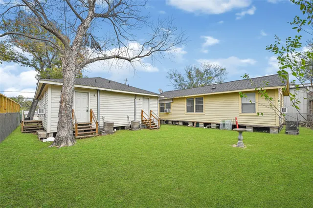 a backyard of a house with table and chairs