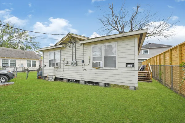 a front view of a house with a yard table and chairs