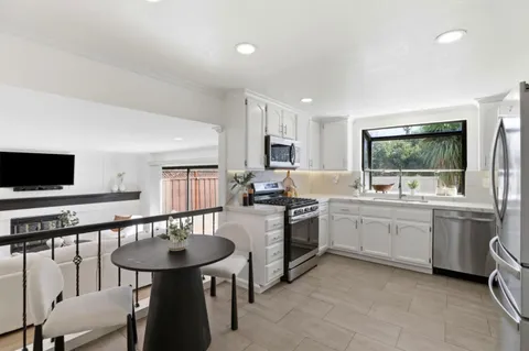 a spacious bedroom with a bed a couch and a window