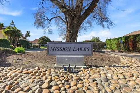 a living room with furniture a fireplace and a chandelier
