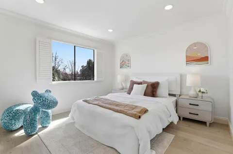 a bedroom with a bed and a painting on the wall