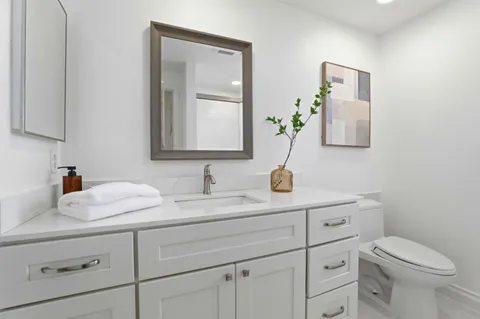 a backyard of a house with table and chairs under an umbrella