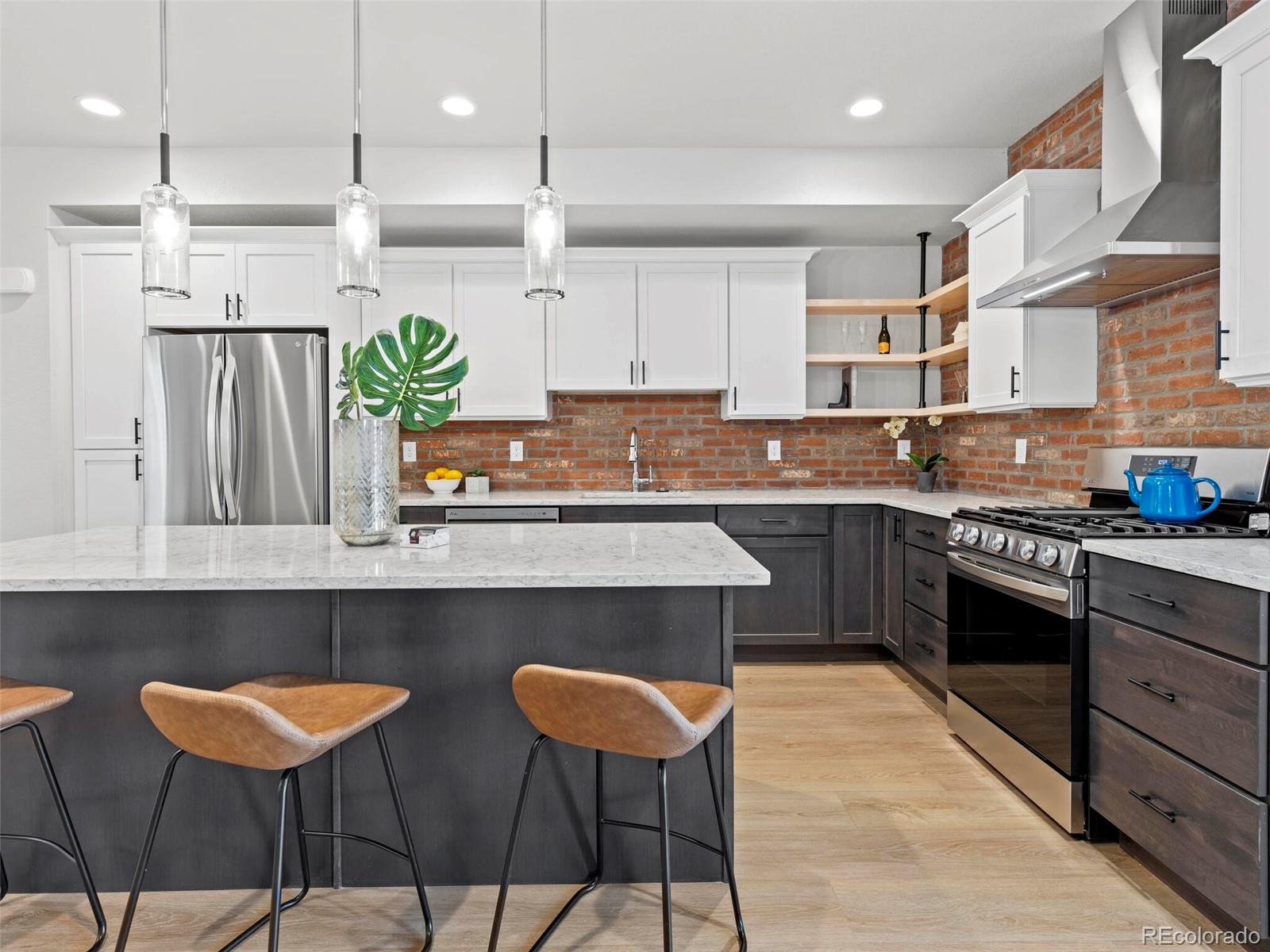 a kitchen with cabinets and chairs