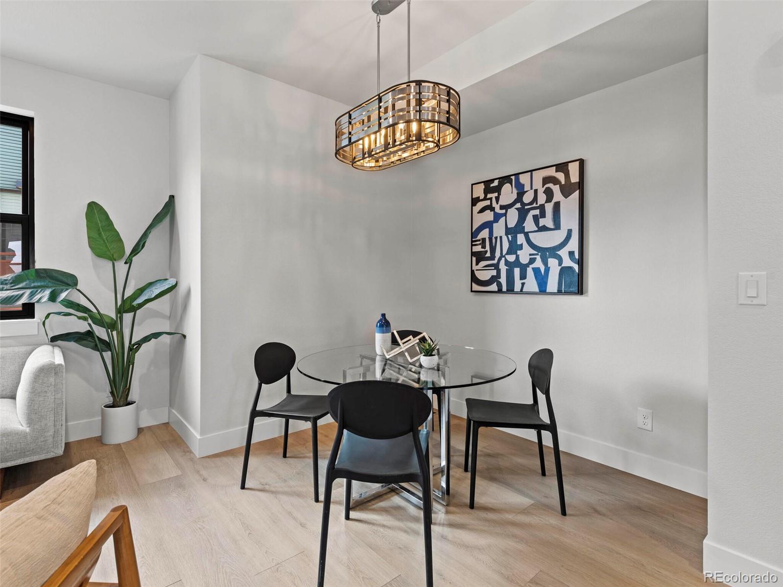 5423 South Prince Street, Unit B Littleton, CO 80120 - Photo 12 of 40 a view of a dining room with furniture window and wooden floor