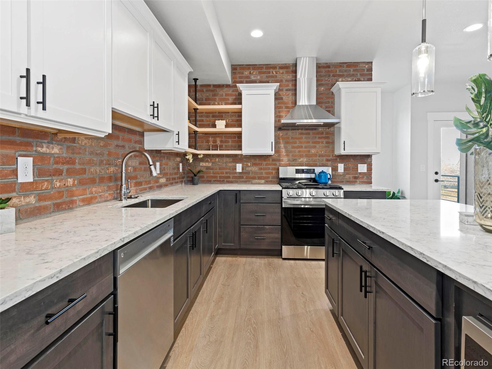5423 South Prince Street, Unit B Littleton, CO 80120 - Photo 14 of 40 a kitchen with stainless steel appliances granite countertop sink a stove and cabinets