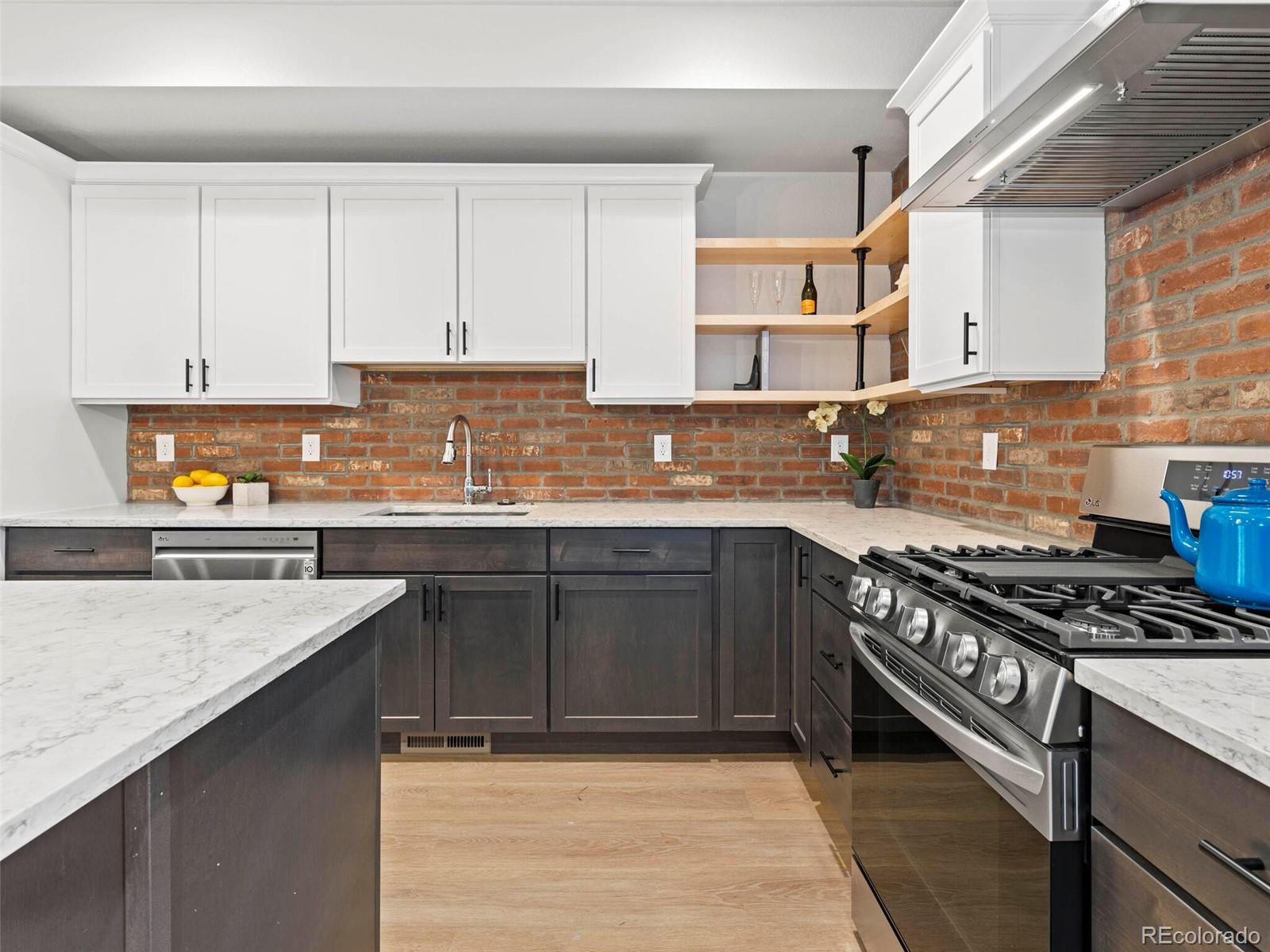 5423 South Prince Street, Unit B Littleton, CO 80120 - Photo 16 of 40 a kitchen with stainless steel appliances granite countertop a sink stove and cabinets
