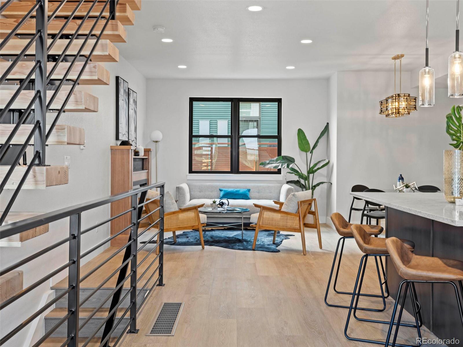 5423 South Prince Street, Unit B Littleton, CO 80120 - Photo 18 of 40 a living room with furniture a wooden floor and a window
