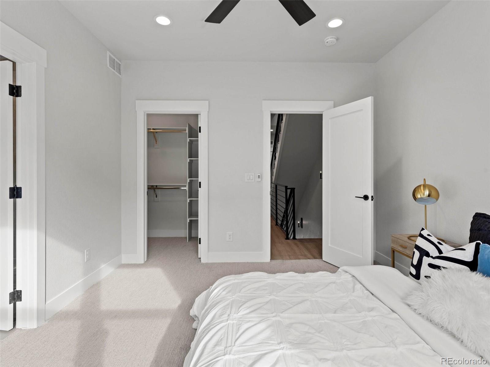 5423 South Prince Street, Unit B Littleton, CO 80120 - Photo 22 of 40 a bedroom with a bed and a chandelier