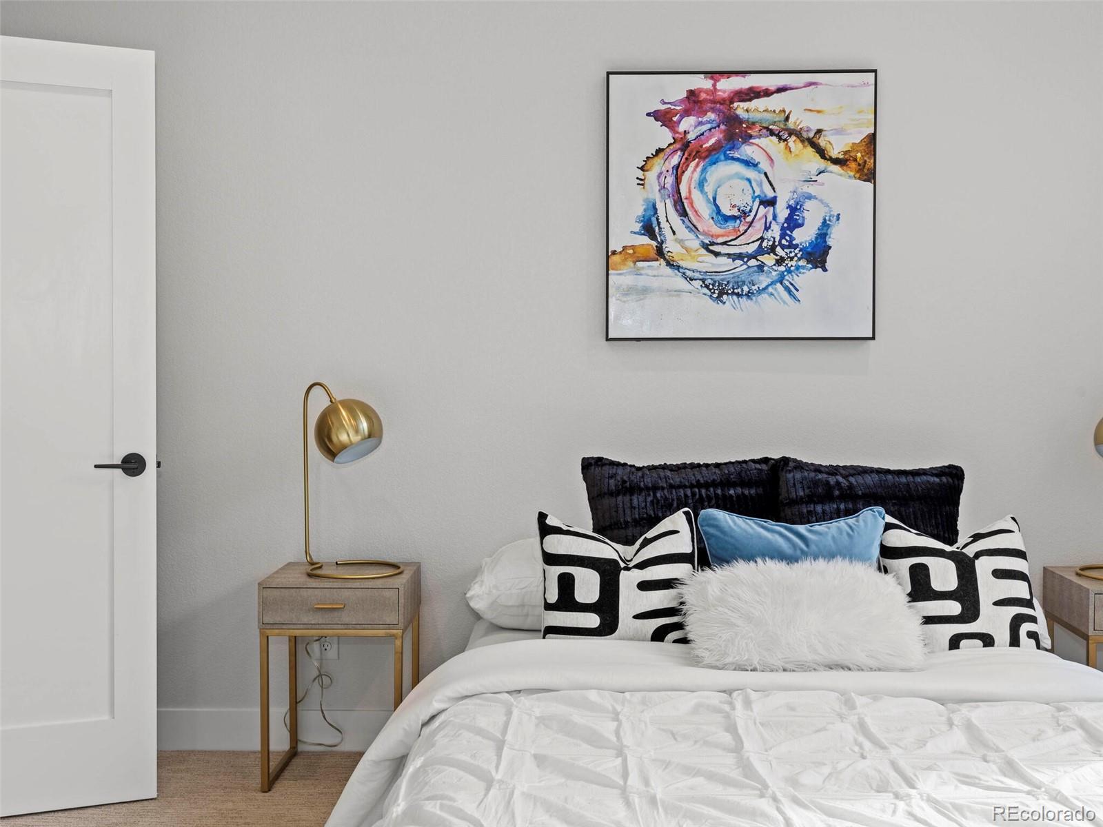 5423 South Prince Street, Unit B Littleton, CO 80120 - Photo 25 of 40 a bedroom with a bed and a wall painting