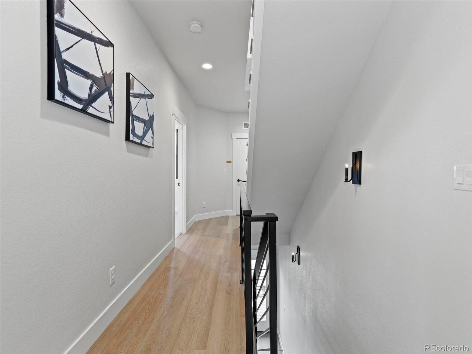5423 South Prince Street, Unit B Littleton, CO 80120 - Photo 26 of 40 a view of a hallway with wooden floor