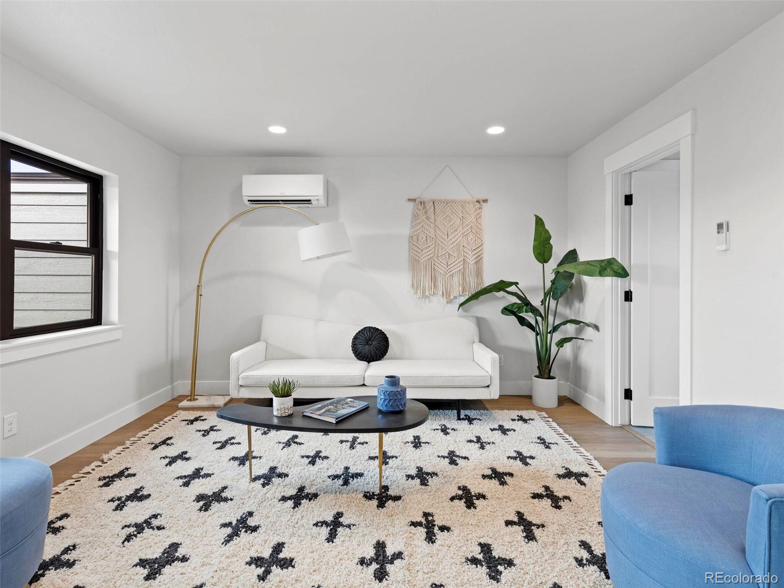 5423 South Prince Street, Unit B Littleton, CO 80120 - Photo 34 of 40 a living room with a couch and a rug