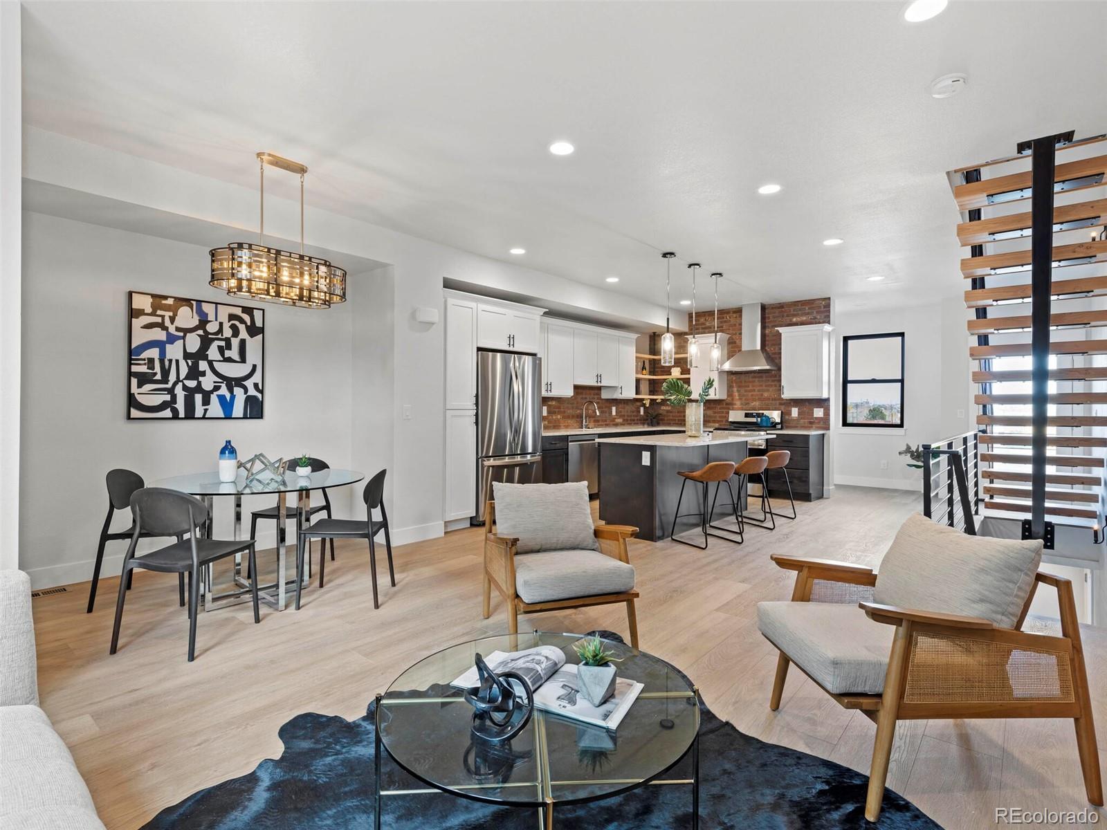 5423 South Prince Street, Unit B Littleton, CO 80120 - Photo 6 of 40 a living room with furniture kitchen view and a chandelier