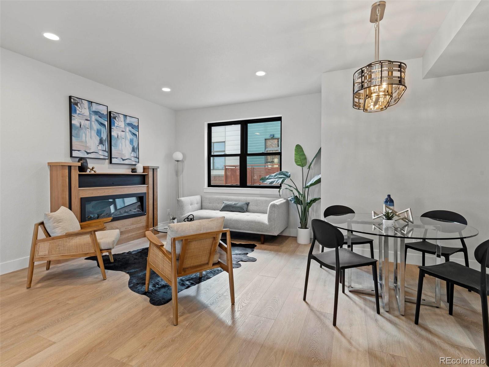5423 South Prince Street, Unit B Littleton, CO 80120 - Photo 9 of 40 a living room with furniture two window and a table