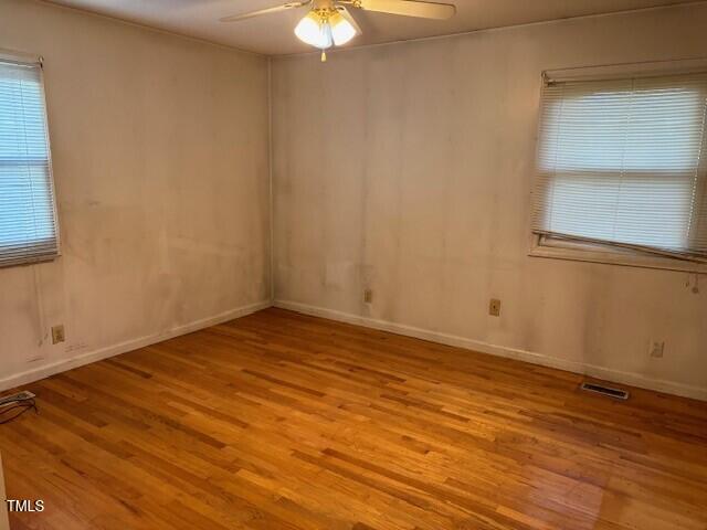 809 Simmons Street Durham, NC 27701 - Photo 10 of 16 a view of empty room with wooden floor and fan