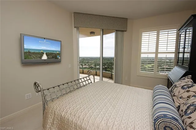 a bathroom with a granite countertop sink a toilet a mirror and shower