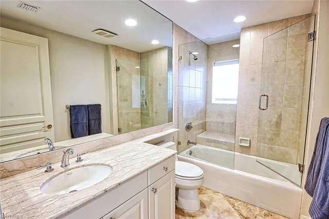 a bathroom with a granite countertop sink and a large mirror