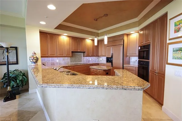 a kitchen with stainless steel appliances granite countertop a sink stove and cabinets