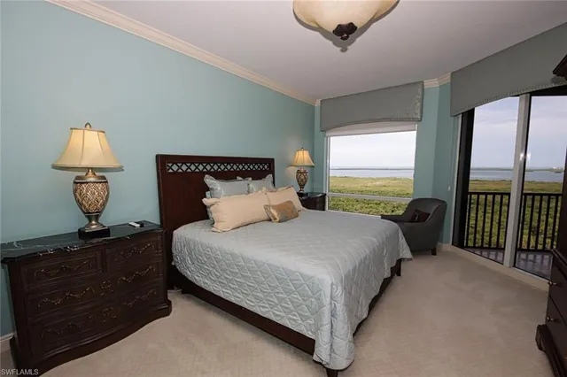 a bedroom with a bed and cabinets