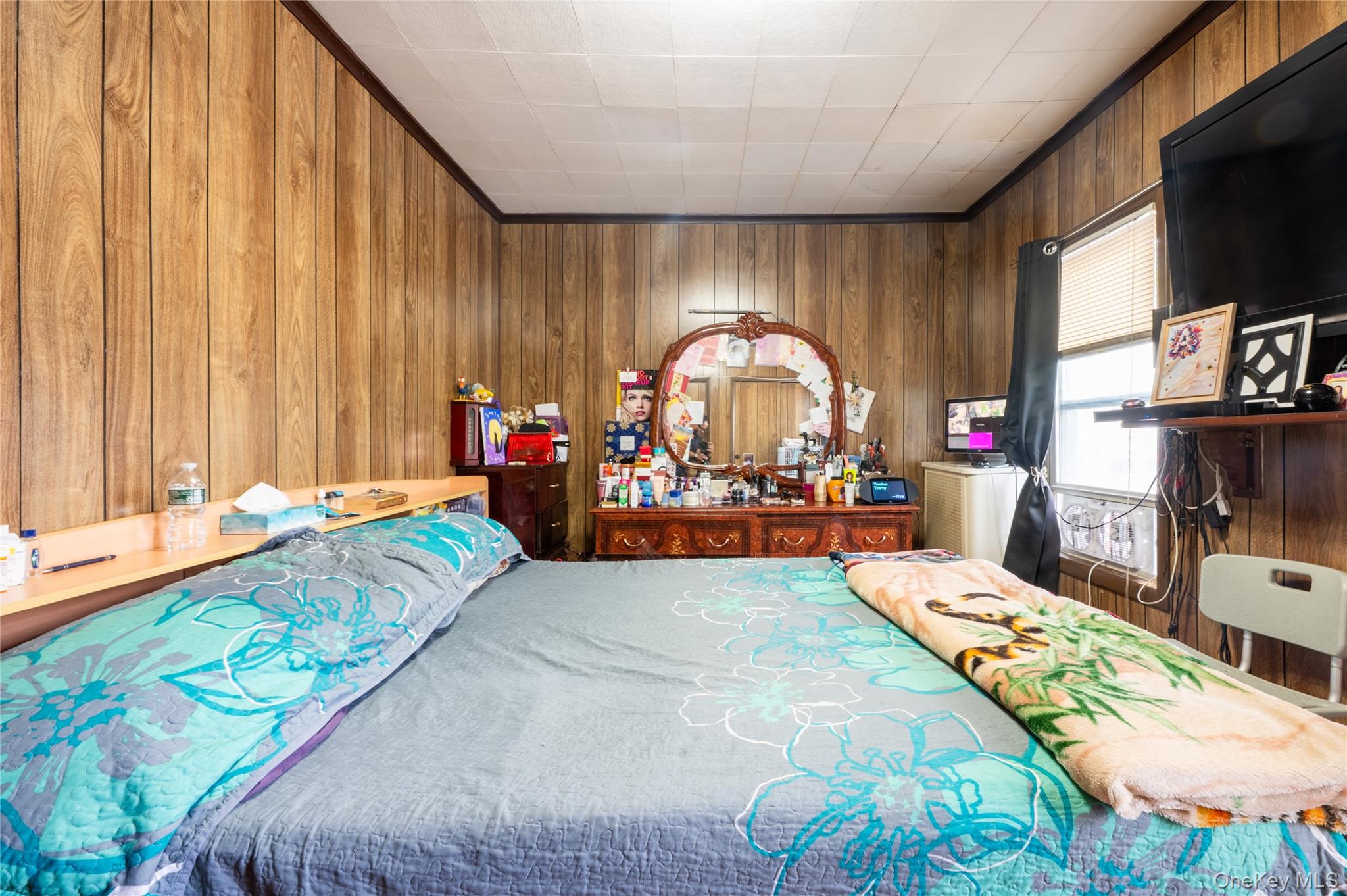 104-48 Lefferts Boulevard Queens, NY 11419 - Photo 11 of 22 a living room filled with furniture and a flat screen tv