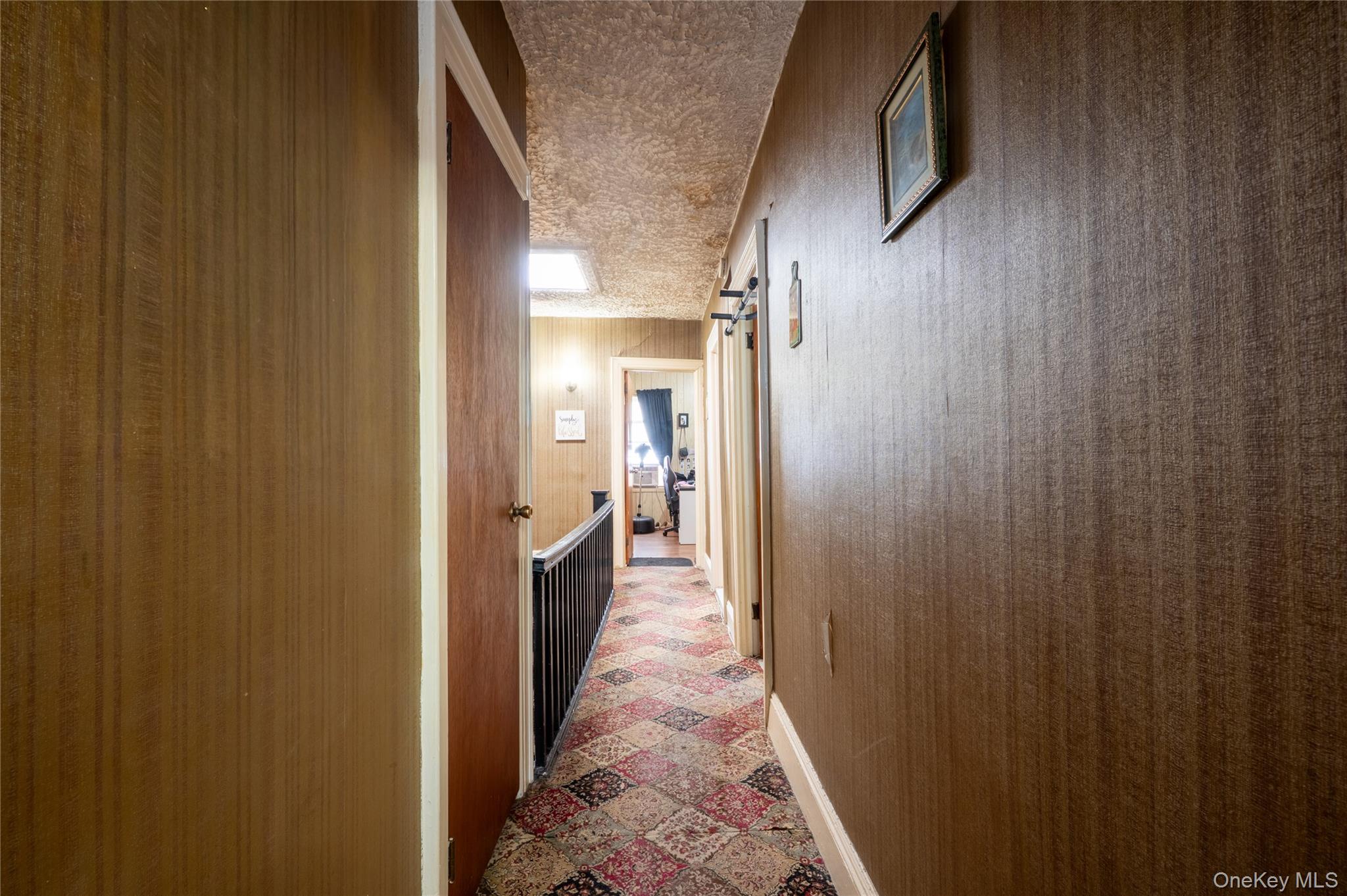 104-48 Lefferts Boulevard Queens, NY 11419 - Photo 13 of 22 a view of hallway with wooden floor