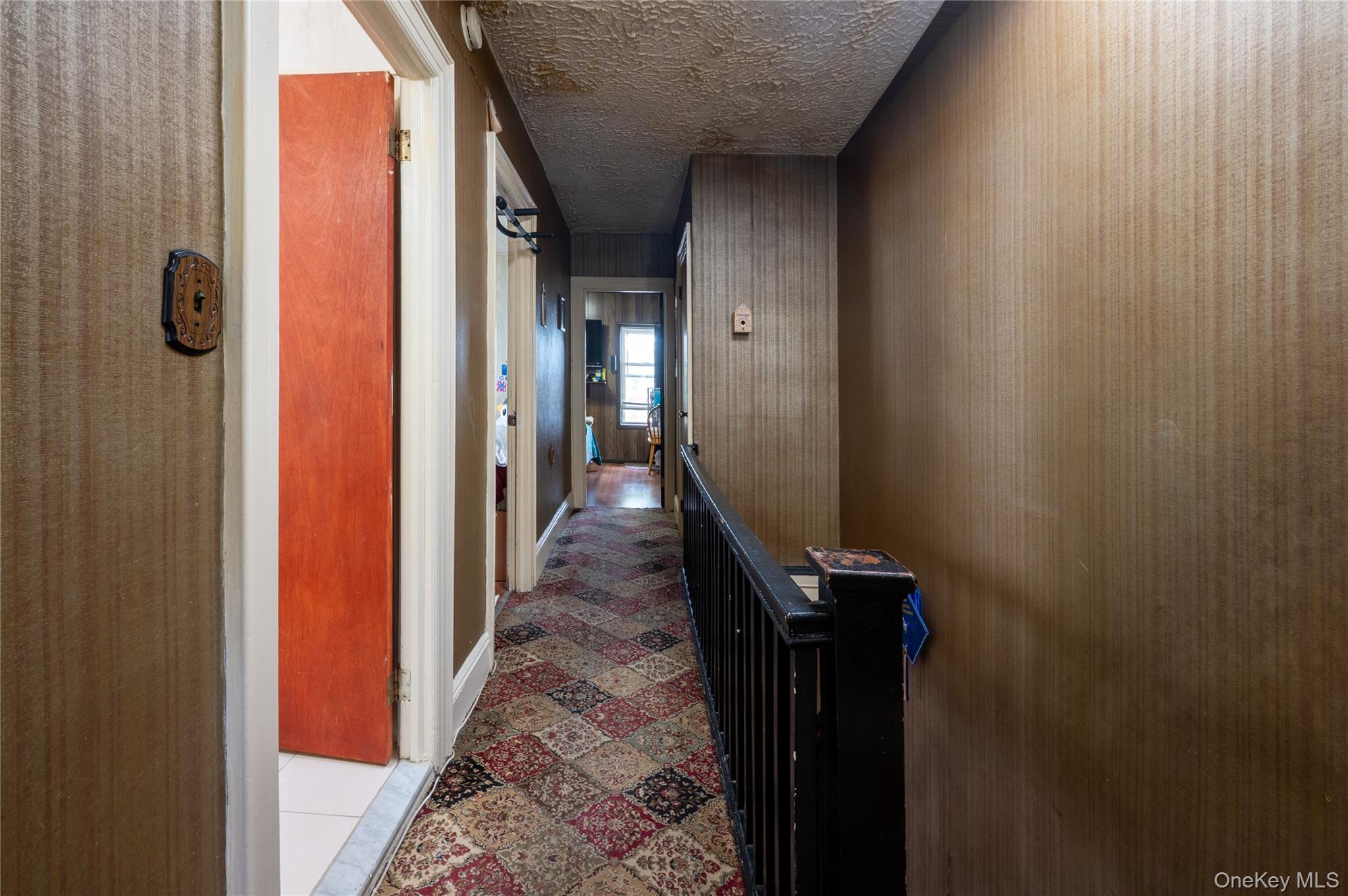 104-48 Lefferts Boulevard Queens, NY 11419 - Photo 14 of 22 a hallway with front door and wooden stairs