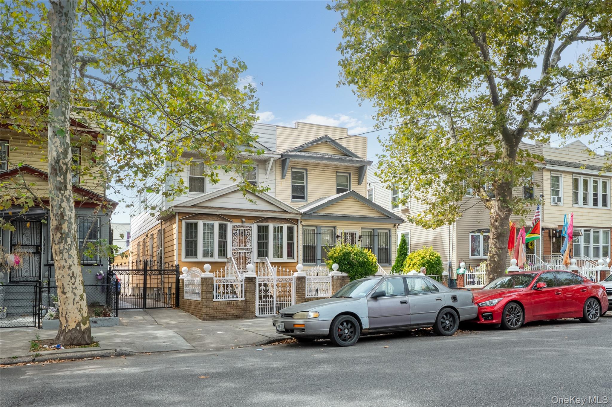 104-48 Lefferts Boulevard Queens, NY 11419 - Photo 2 of 22 a car parked in front of a white house