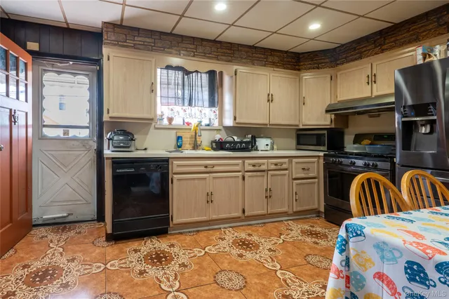 a kitchen with stainless steel appliances granite countertop a sink and cabinets