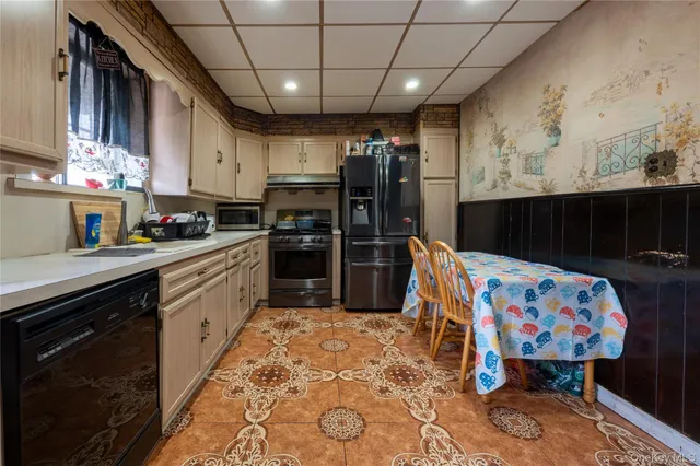 a kitchen with stainless steel appliances kitchen island granite countertop a sink dishwasher and cabinets with wooden floor