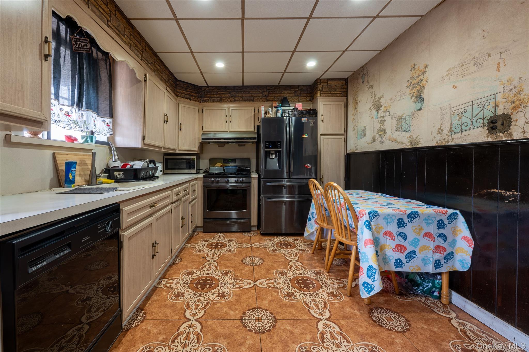 104-48 Lefferts Boulevard Queens, NY 11419 - Photo 10 of 22 a kitchen with stainless steel appliances kitchen island granite countertop a sink dishwasher and cabinets with wooden floor