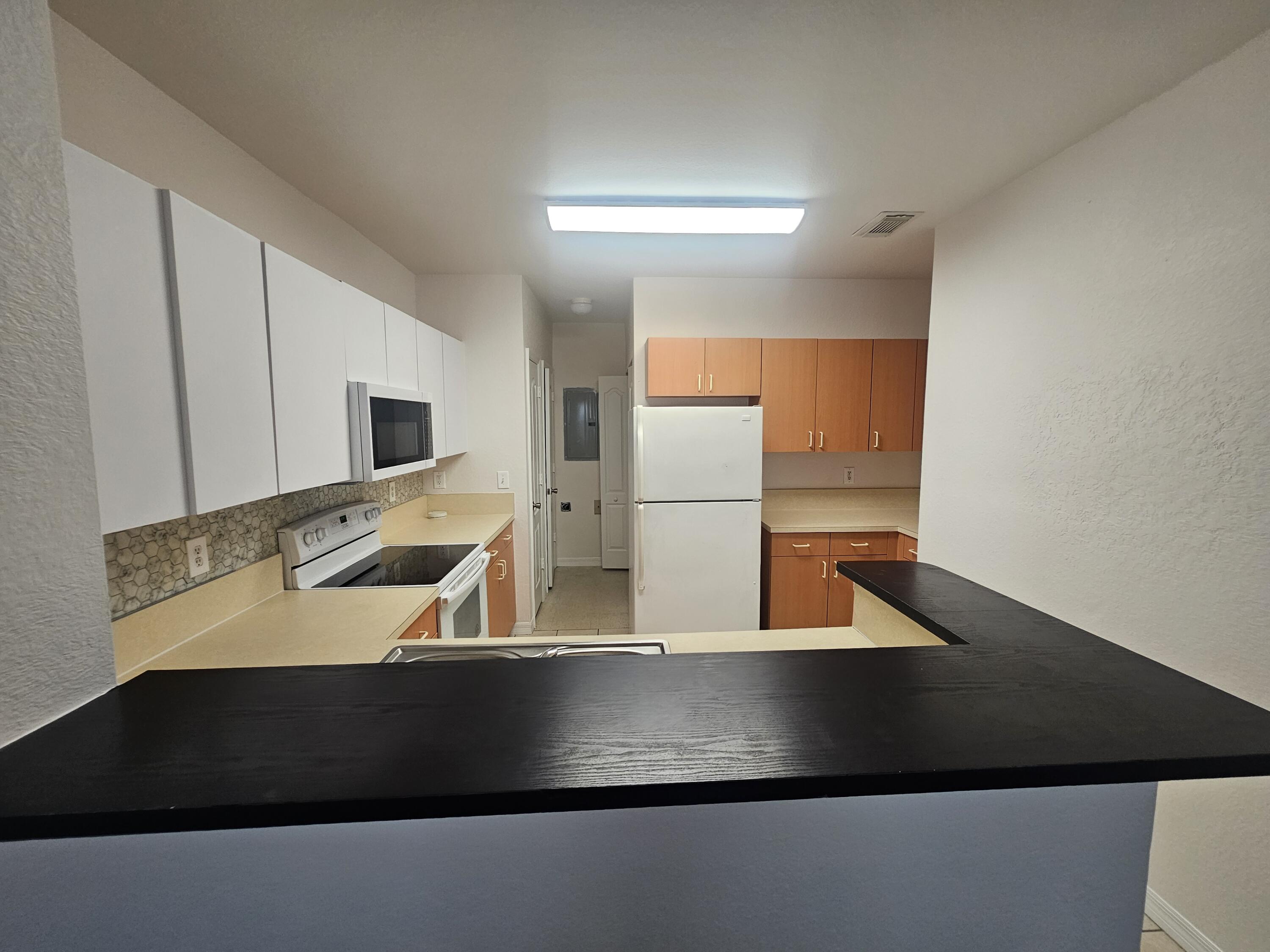 118 Southwest Peacock Boulevard, Unit 10203 Port St. Lucie, FL 34986 - Photo 6 of 10 a view of kitchen