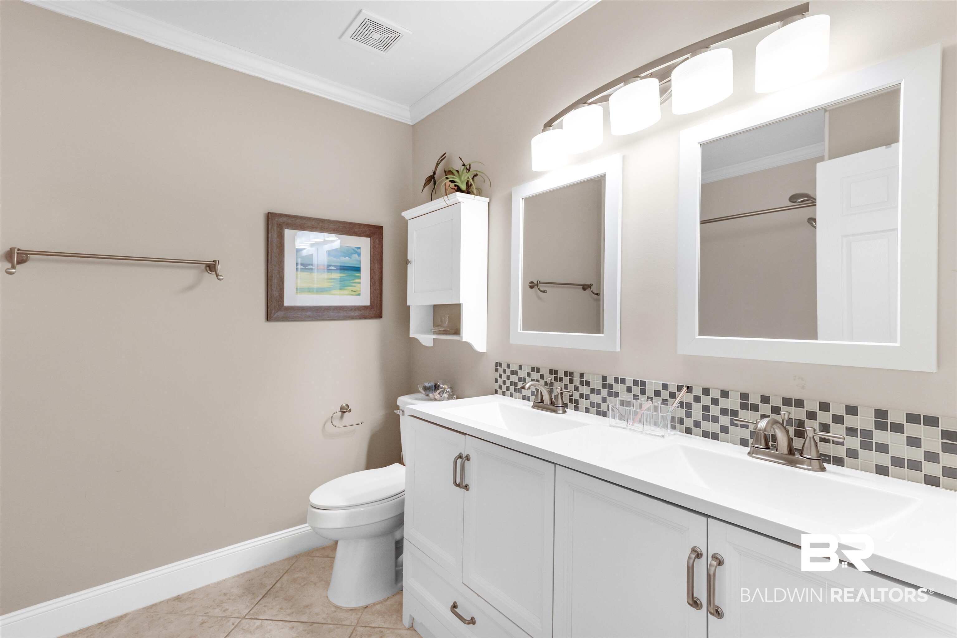 1517 Regency Road, Unit 68 Gulf Shores, AL 36542 - Photo 19 of 43 Bathroom with tile patterned floors, toilet, decorative backsplash, vanity, and ornamental molding
